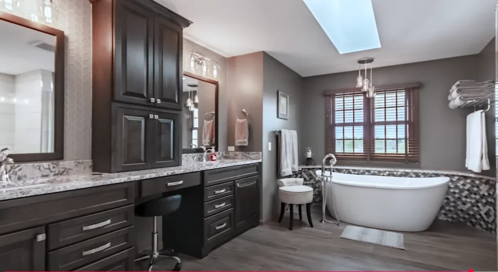 Modern bathroom remodel in Allentown featuring a freestanding tub, dual vanity, and elegant dark cabinetry