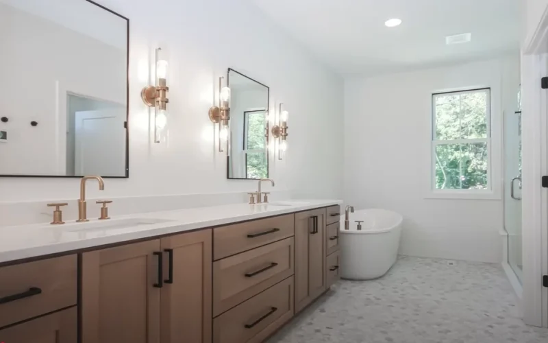 Bright bathroom featuring a freestanding bathtub, marble walls, and a window in Allentown, PA